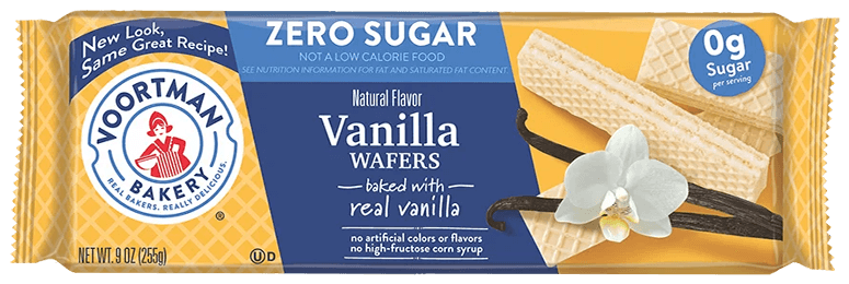 Alt text: "Packaging of Voortman Bakeries Vanilla Wafers. Features 'Zero Sugar' label, wafers and a vanilla flower image, emphasizing natural flavor."
