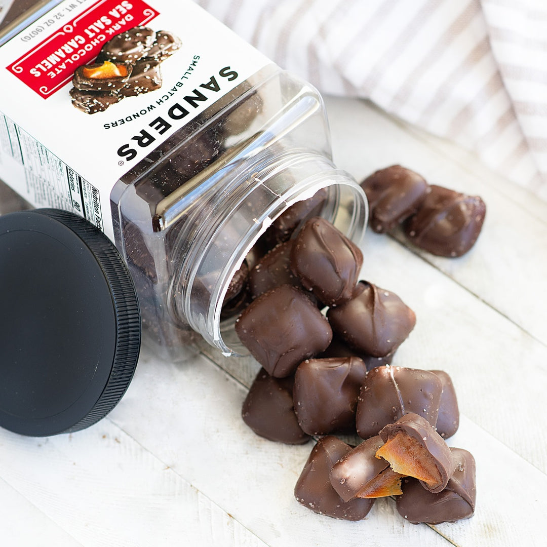 Jar of Sanders chocolate-covered caramel candies on a white surface