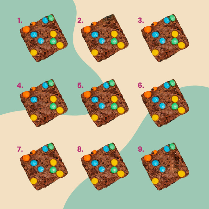 9 chunks of the M&M'S® Minis Brownie Brittle on a multi-colored background