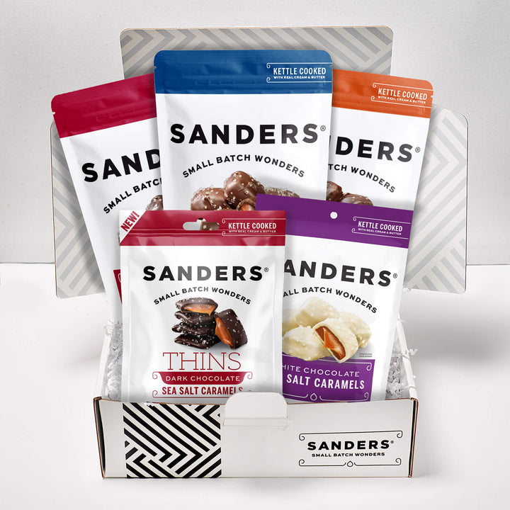 Sanders  gift box featuring five assorted chocolate treats, including milk, dark and white chocolate sea salt caramels, pecan clusters and caramel thins.