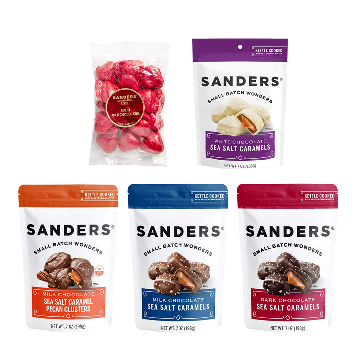 Five bags of Sanders chocolates, each labeled with different flavors: solid milk chocolates, white chocolate sea salt caramels, milk chocolate pecan clusters, milk chocolate sea salt caramels, and dark chocolate sea salt caramels. The packaging is colorful and enticing.