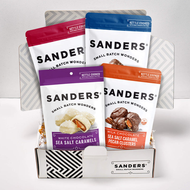Sanders Classic Caramel 4-item gift box with white, milk and dark chocolate sea salt caramels and milk chocolate pecan clusters.