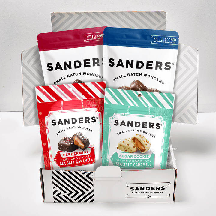 Collection of Sanders candy packages called Decadent Delights Gift Box in a display box on a white background