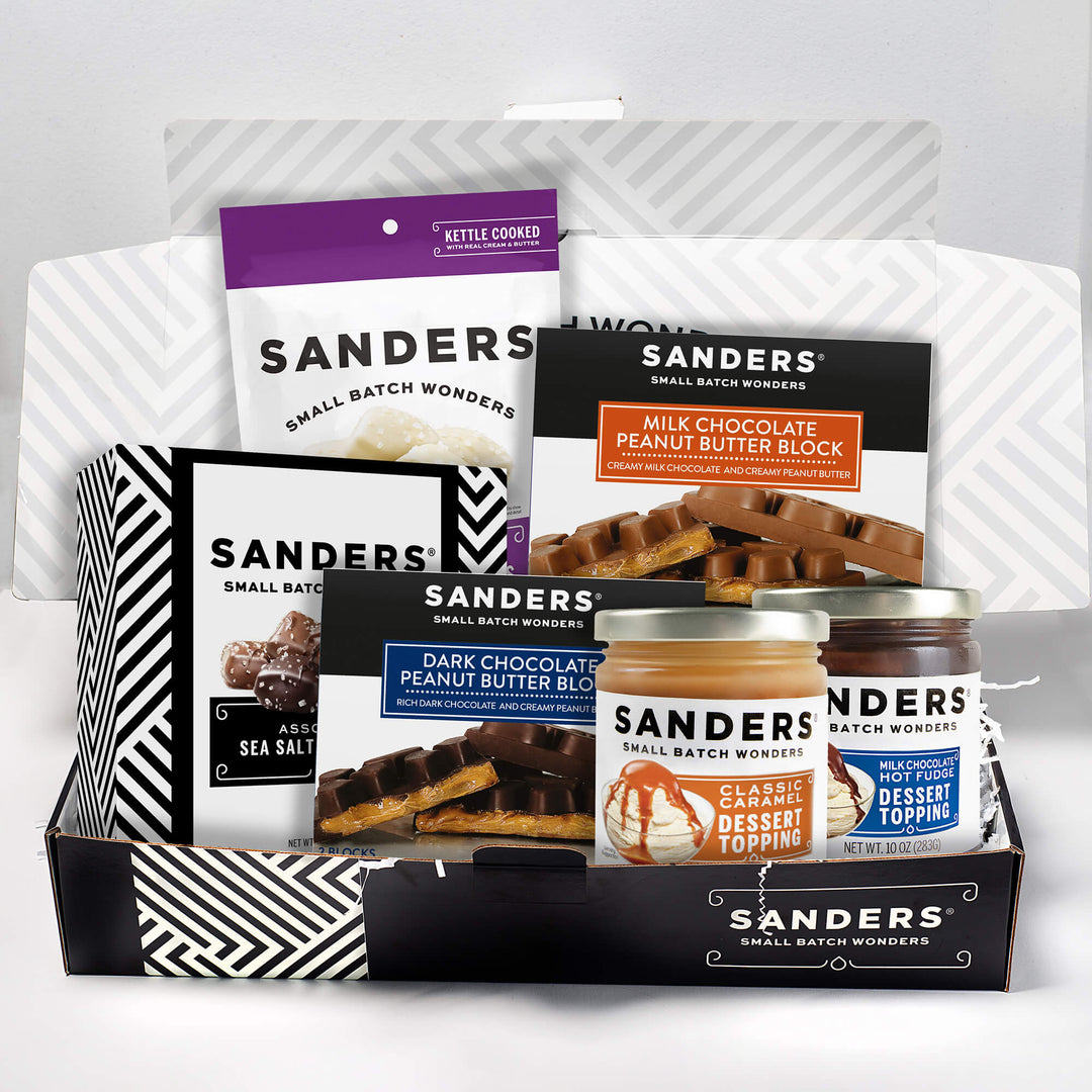 Gift box filled with various Sanders Small Batch Wonders products, including chocolate blocks and dessert toppings, showcasing a mix of sweets.