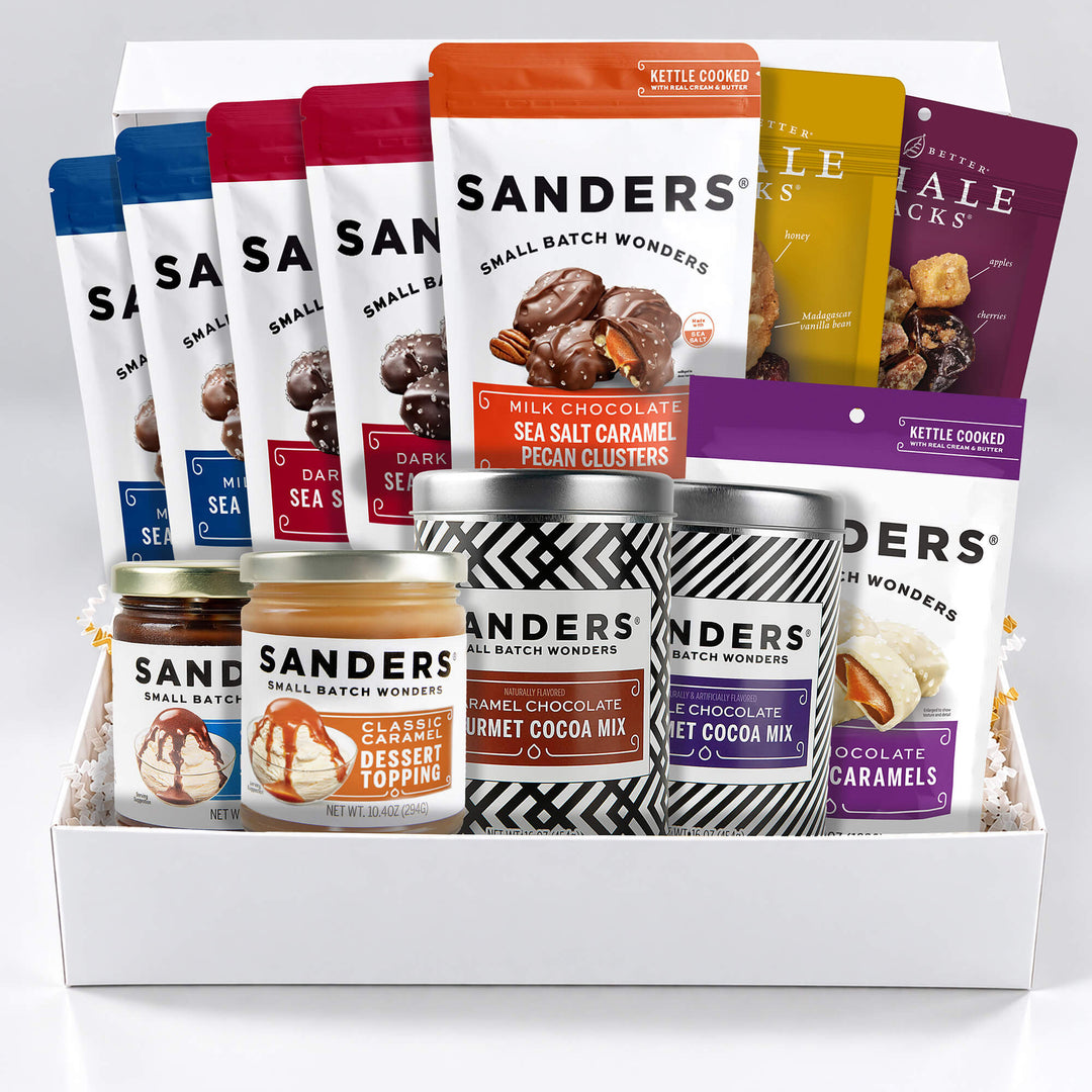 Sanders Grand Chocolate & Nut Gift Box with assorted sea salt caramels, pecan clusters, gourmet cocoa mixes, dessert toppings, and glazed nuts.