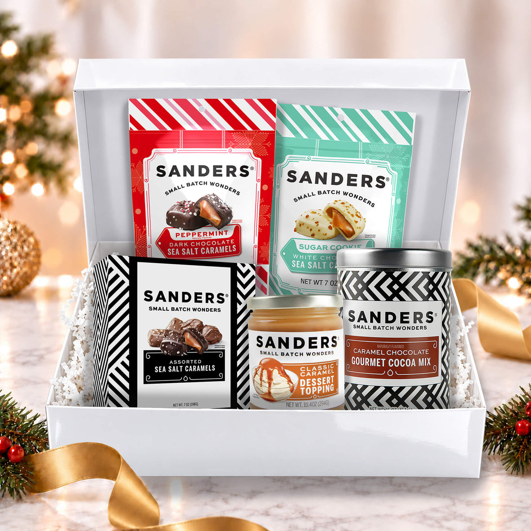 Sanders Holiday Indulgence 5-item gift box with peppermint and sugar cookie sea salt caramels, cocoa mix, and caramel dessert topping.
