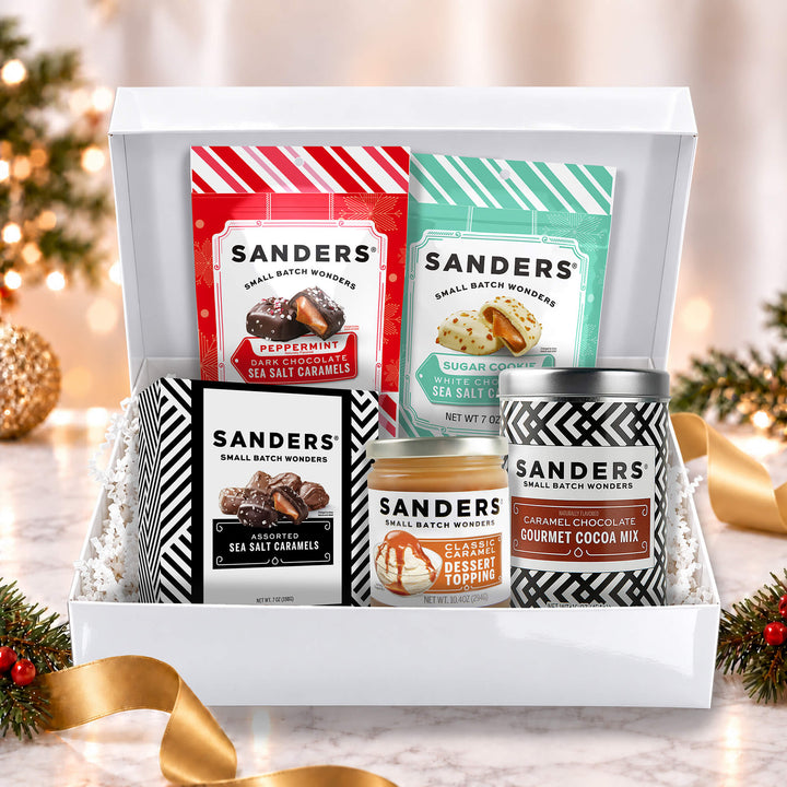 Sanders Holiday Indulgence 5-item gift box with peppermint and sugar cookie sea salt caramels, cocoa mix, and caramel dessert topping.