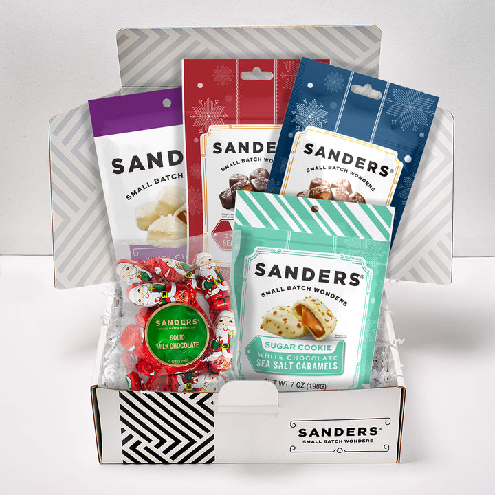 Collection of Sanders chocolate bars and cookies in a box on a white background