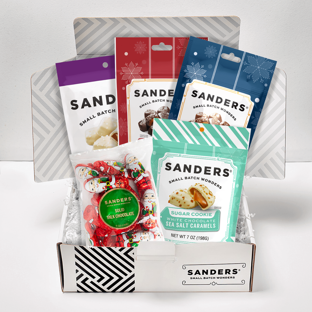 Assorted Sanders candy packages displayed in a box on a white background
