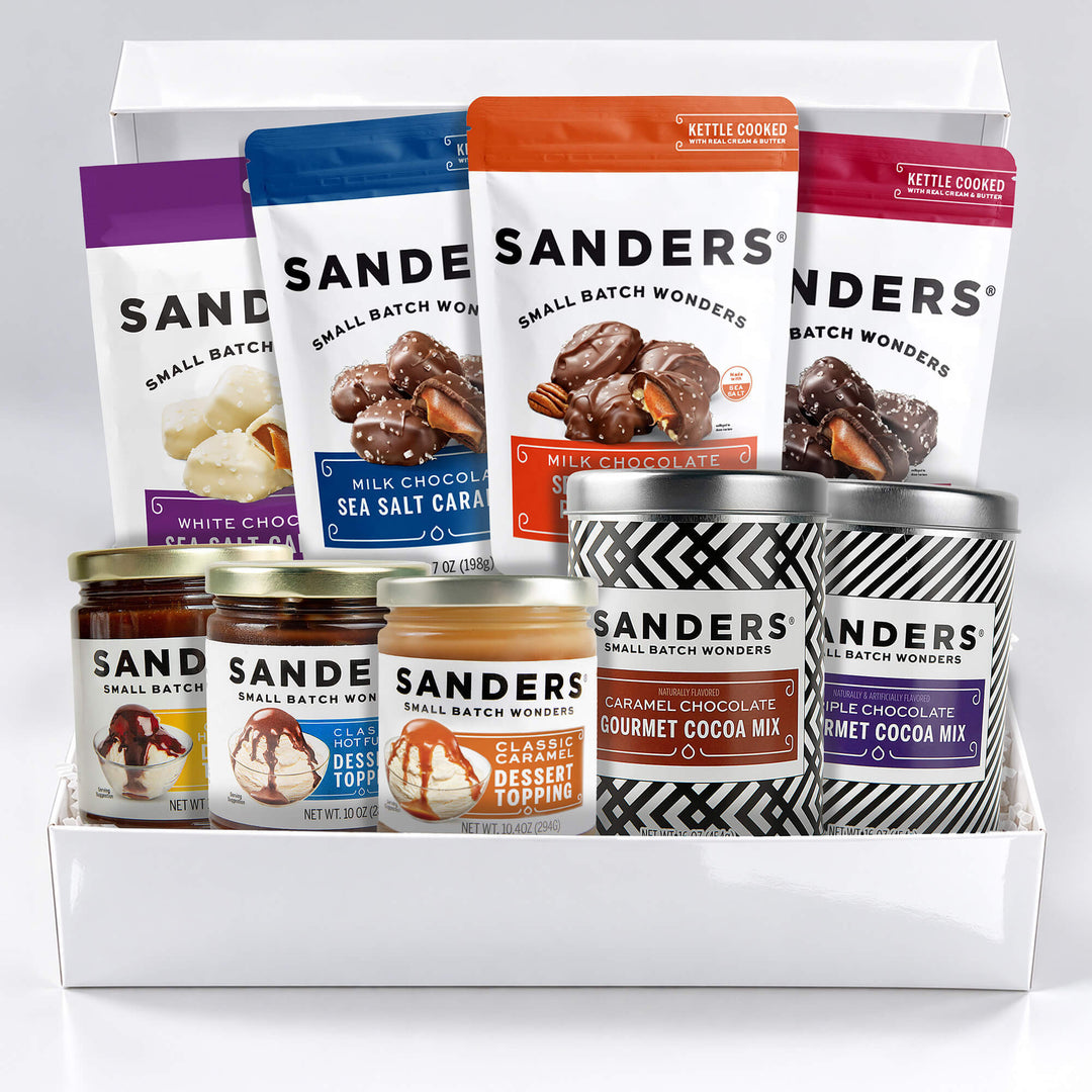 Sanders Signature 9-item gift box with assorted sea salt caramels, pecan clusters, gourmet cocoa mixes, and dessert toppings.