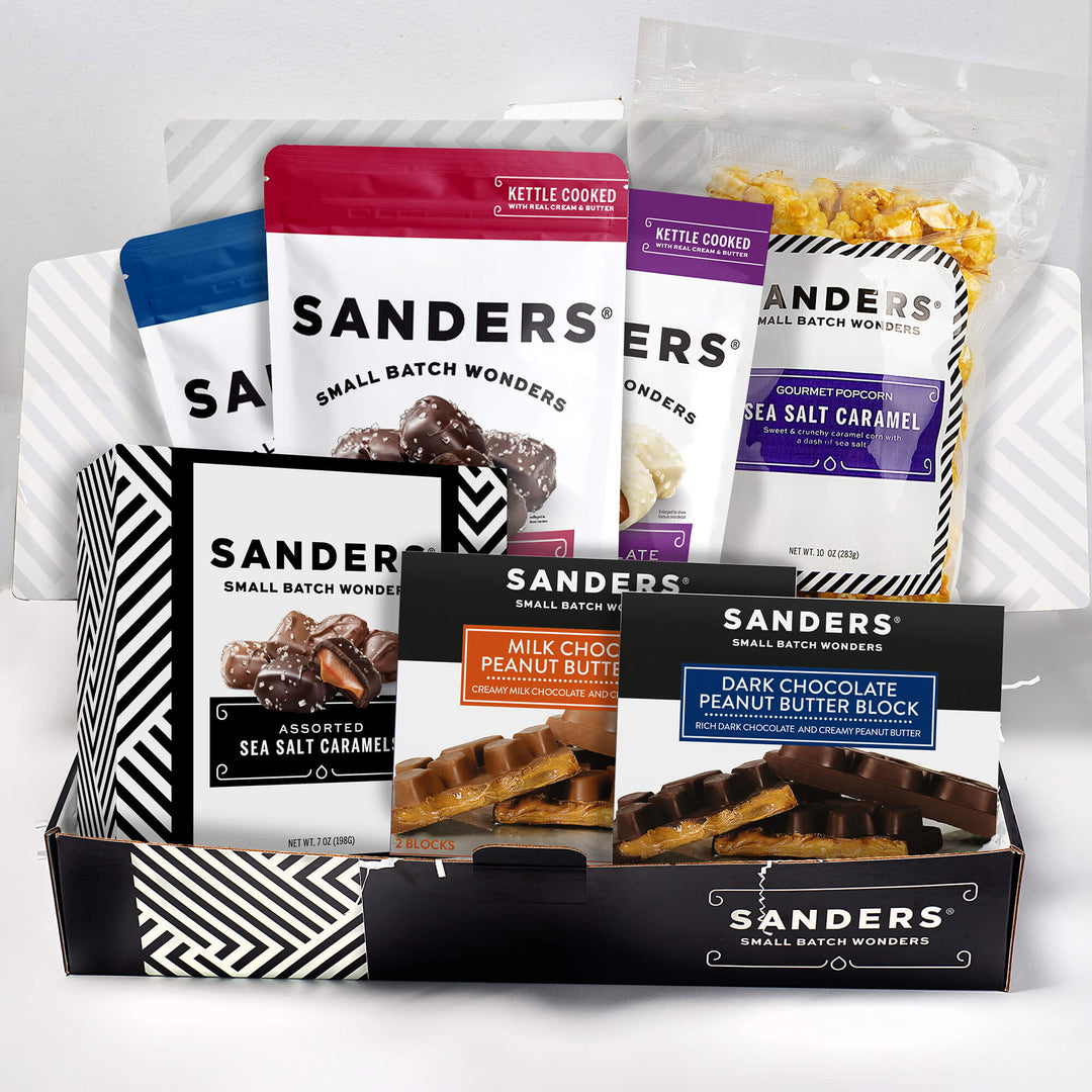 A collection of Sanders chocolate and caramel products in colorful packaging, featuring varieties like peanut butter blocks and sea salt caramel. Packaging is vibrant and enticing.