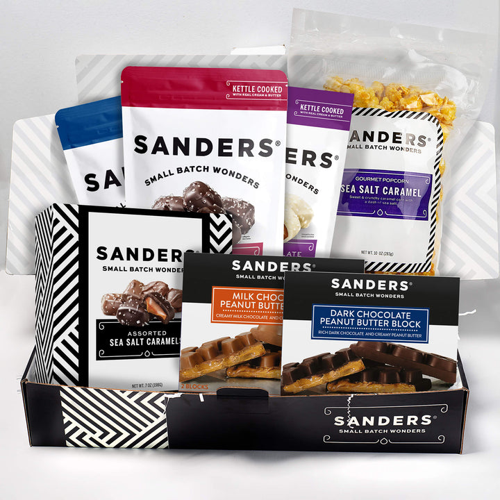 A collection of Sanders chocolate and caramel products in colorful packaging, featuring varieties like peanut butter blocks and sea salt caramel. Packaging is vibrant and enticing.