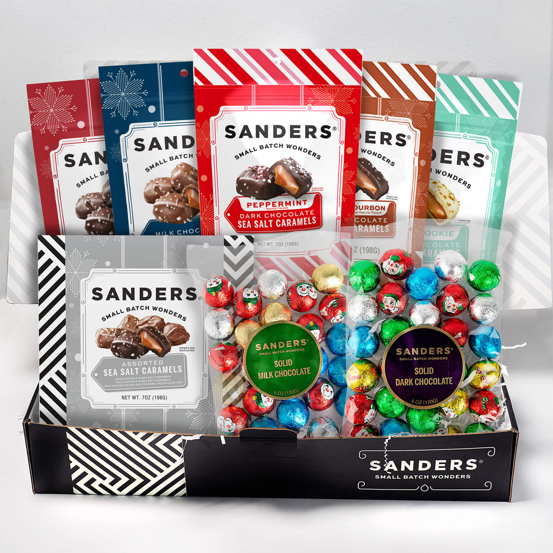 Assorted Sanders chocolate candies in a box with colorful packaging on a white background